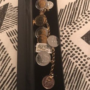A gold chained bracelet with gold and sliver coins